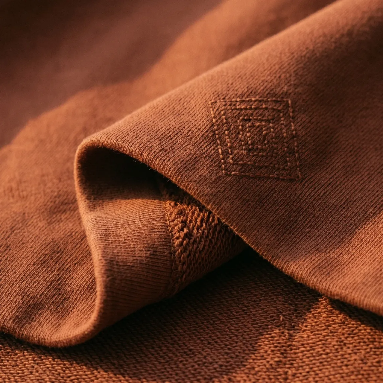 Tone-on-tone jamdani motif on terracotta loopback